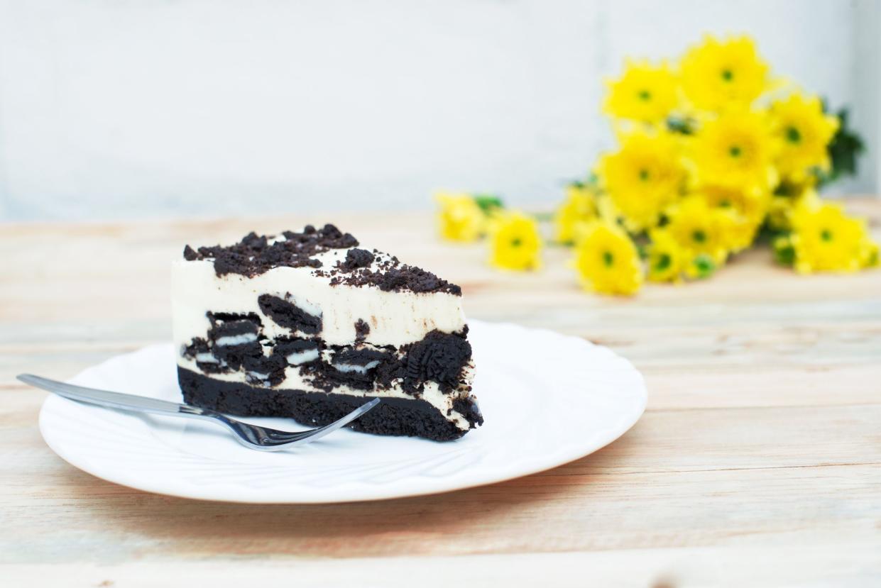 a piece of cookies and cream cheesecake on white ceramic plate