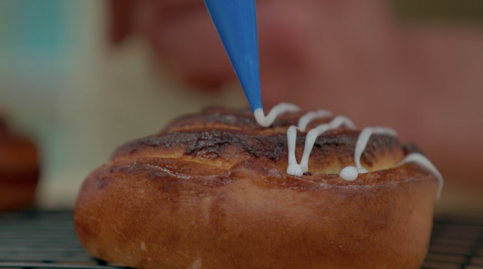 Giuseppe icing a burnt bun