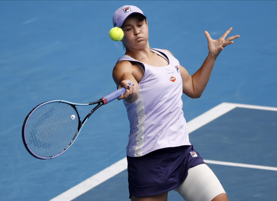 Australia's Ash Barty makes a forehand return to compatriot Daria Gavrilova during their second round match at the Australian Open tennis championship in Melbourne, Australia, Thursday, Feb. 11, 2021.(AP Photo/Rick Rycroft)