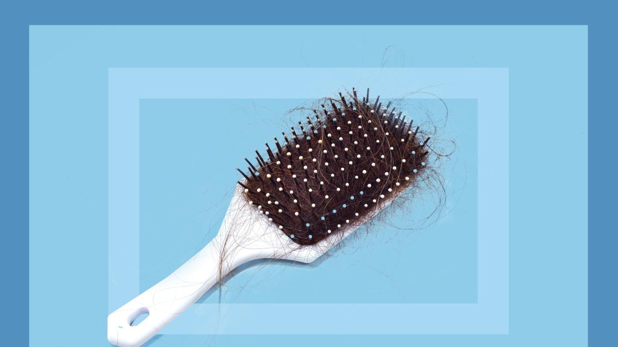 dirty hairbrush with stray hairs