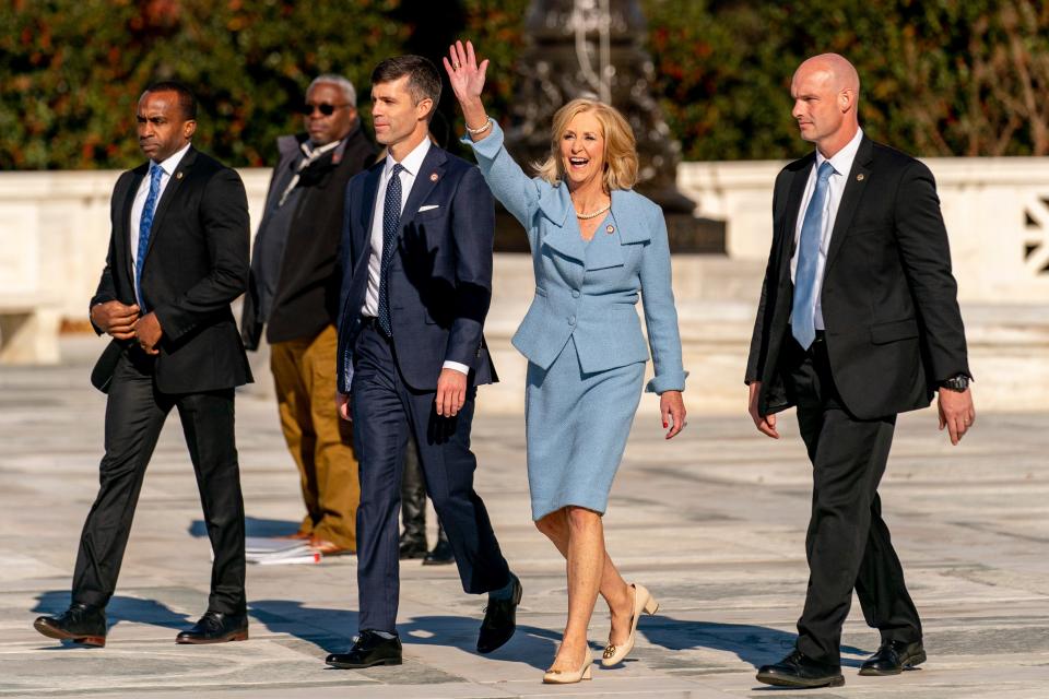 Mississippi Attorney General Lynn Fitch, center right, accompanied by Mississippi Solicitor General Scott Stewart, center left, waves to supporters as they walk out of of the U.S. Supreme Court, Wednesday, Dec. 1, 2021, in Washington, after the court heard arguments in a case from Mississippi, where a 2018 law would ban abortions after 15 weeks of pregnancy, well before viability.