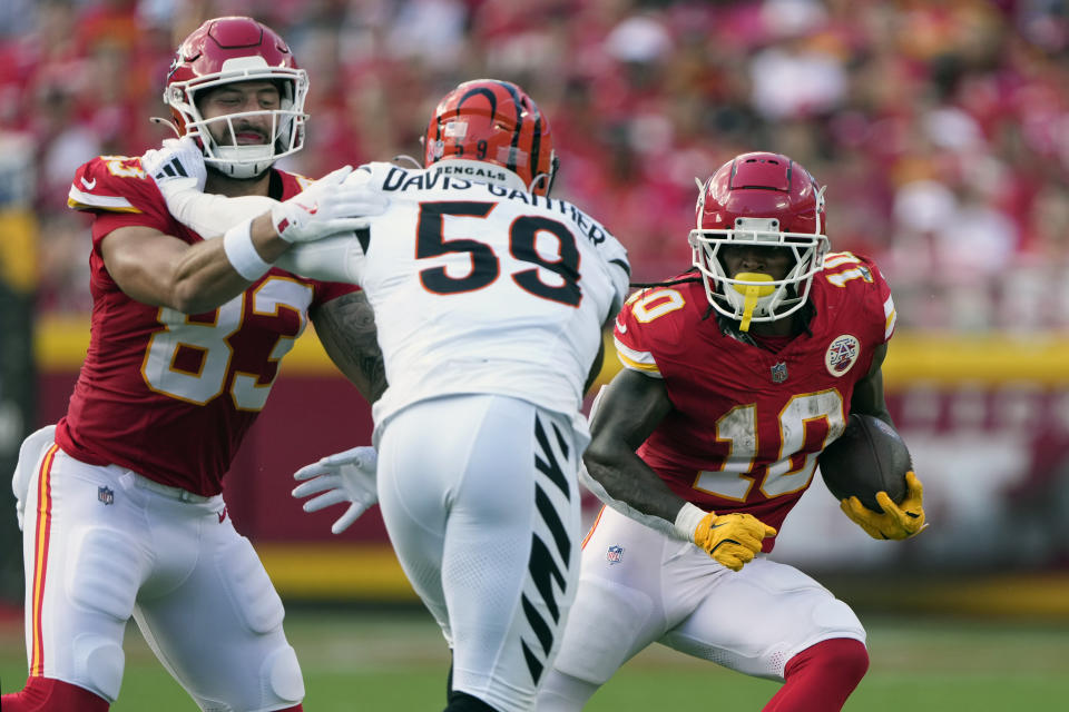 Kansas City Chiefs running back Isiah Pacheco (10) runs with the ball as Cincinnati Bengals linebacker Akeem Davis-Gaither (59) is blocked by Chiefs tight end Noah Gray (83) defends during the first half of an NFL football game Sunday, Sept. 15, 2024, in Kansas City, Mo. (AP Photo/Charlie Riedel)