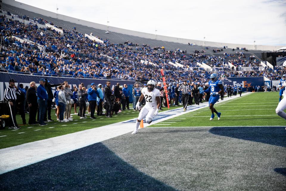 The University of Central Florida's running back RJ Harvey (22) runs into the end zone to score a touchdown against the Memphis Tigers' defense at Simmons Bank Liberty Stadium in Memphis.