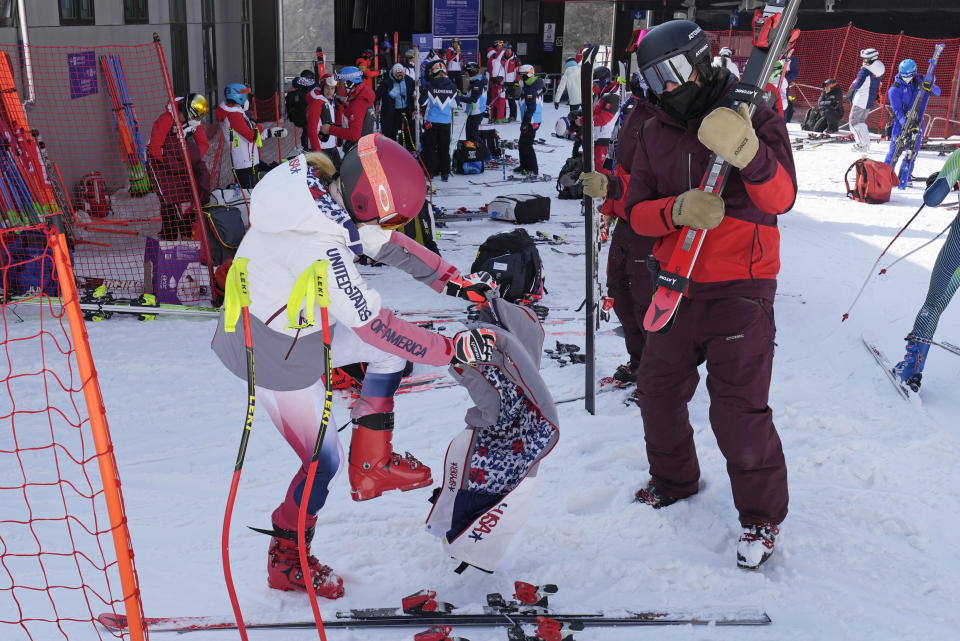 Mikaela Shiffrin of the United States puts on her ski pants before heading to the gondola to go up the alpine ski course for a training run at the 2022 Winter Olympics, Thursday, Feb. 10, 2022, in the Yanqing district of Beijing. Two-time Olympic champion and pre-games medal favorite, Mikaela Shiffrin has skied out in the first run of both the slalom and giant slalom. (AP Photo/Luca Bruno)