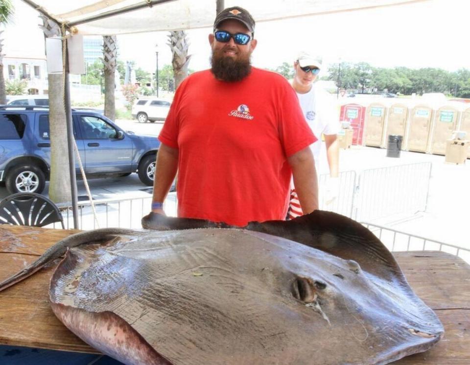 Phillip Ladner of Waveland poses with his 149-pound, 9-ounce stingray at the Mississippi Deep Sea Fishing Rodeo at Barksdale Pavilion in Gulfport on Tuesday, July 4, 2017.