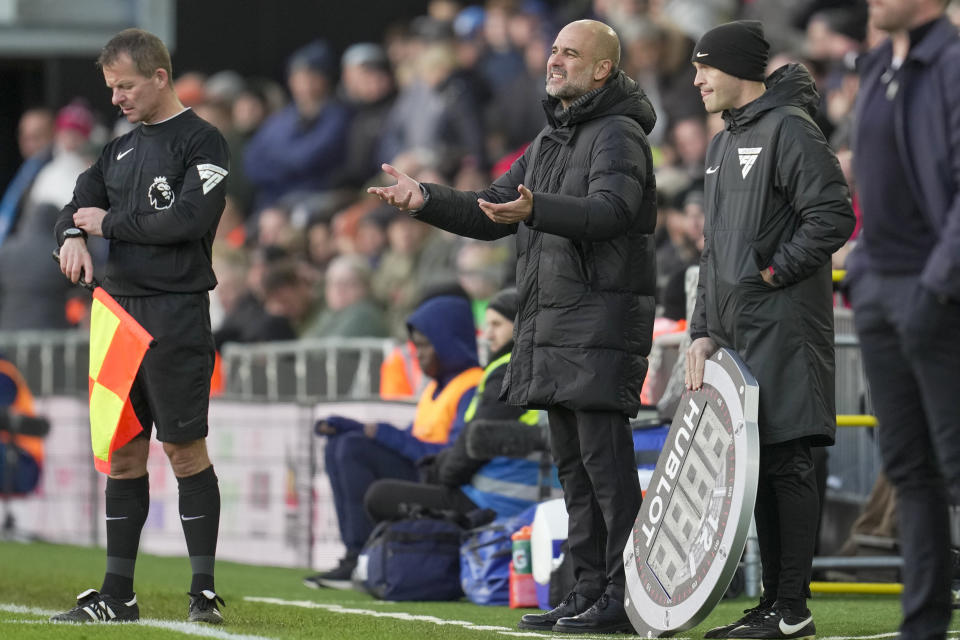 Manchester City's head coach Pep Guardiola, center, reacts during the English Premier League soccer match between Luton Town and Manchester City at Kenilworth Road stadium in Luton, England, Sunday Dec. 10, 2023. (AP Photo/Kin Cheung)