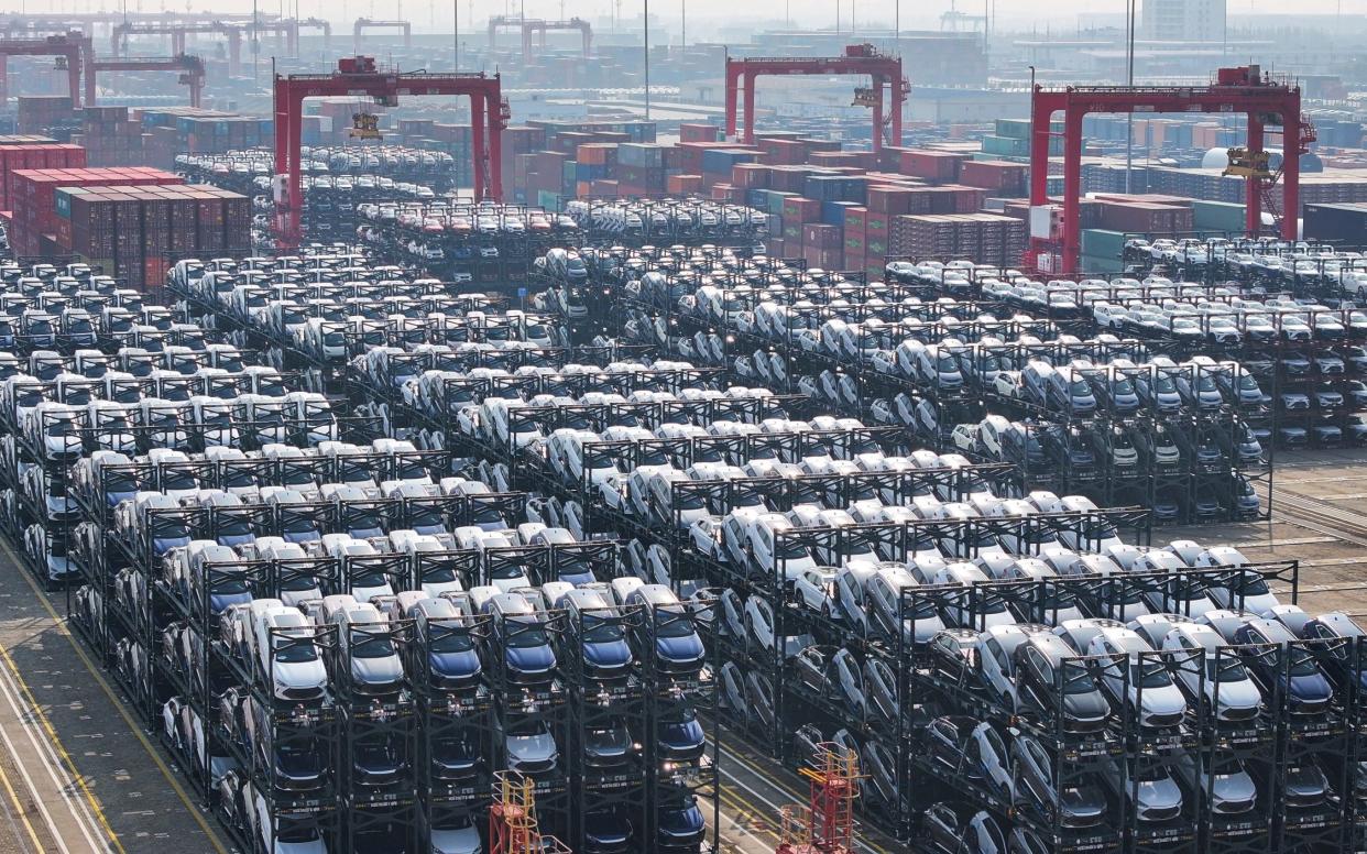 BYD electric cars waiting to be loaded onto a ship are seen stacked at the international container terminal of Taicang Port in Suzhou