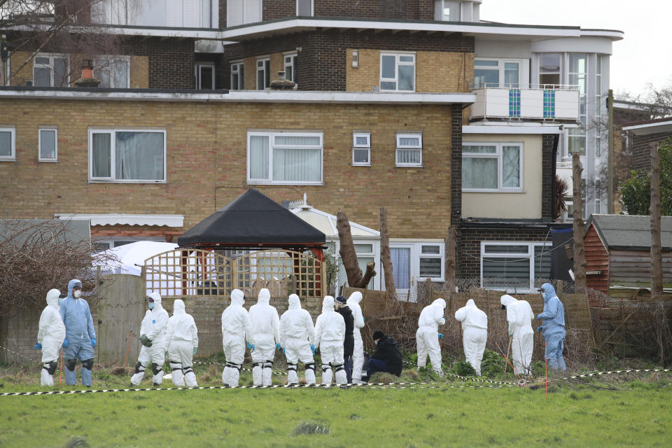 Forensic officers conduct a search behind a house in Deal, Kent, on Friday. (PA)