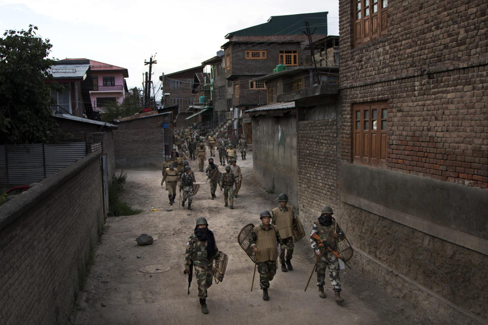 FILE - In this Aug. 18, 2016 file photo, Indian paramilitary soldiers walk back towards their base camp after a day long curfew in Srinagar, Indian controlled Kashmir. A prominent rights group in Indian-controlled Kashmir is advocating United Nations to establish a commission of inquiry to probe endemic use of torture by government forces who have faced decades long anti-India uprising in the disputed region. (AP Photo/Dar Yasin, File)