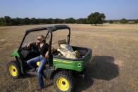 Gilda Jackson sits in her utility vehicle on a 35-acre pasture that is usually filled with 3-feet tall hay on her property in Paradise, Texas, Monday, Aug. 21, 2022. Many farmers, including Jackson, might see a benefit in the next 50 years from installing irrigation infrastructure. (AP Photo/Tony Gutierrez)