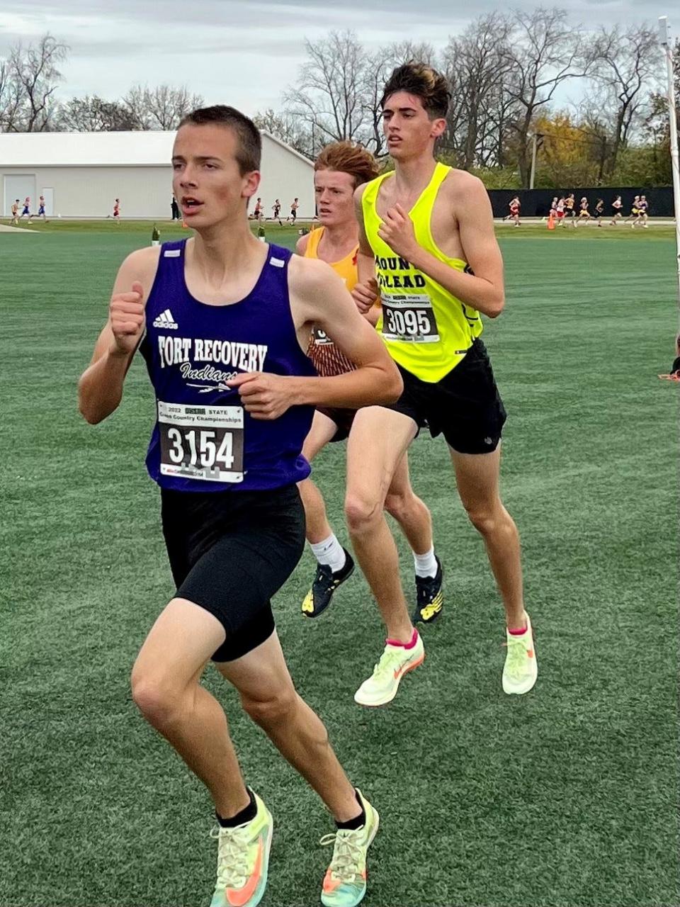 Mount Gilead's Aaron Gannon, right, runs during the Division III boys cross country state championship race at Fortress Obetz Saturday morning.