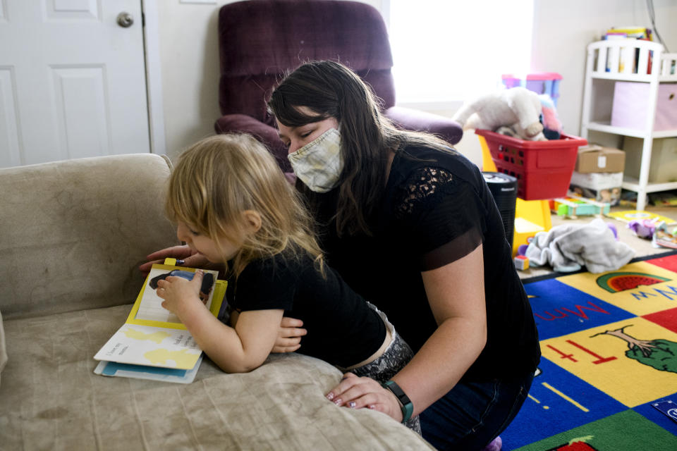 Amy, a behavior technician works with Moira Gillilland, 2, who has Autism, at the home of Lydia Coe, Moiras mother, in Mason, Mich., on December 21, 2021.  Lydia had been utilizing the Child Tax Credit to help support her family. (Credit: Brittany Greeson for The Washington Post via Getty Images)