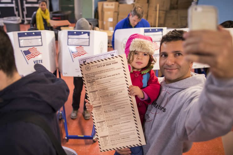 A man takes a selfie with his child at a polling station in New York on Nov. 8. (Photo: Alexander F. Yuan/AP)