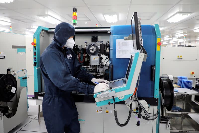 A worker monitors operations at the chip packaging firm Unisem (M) Berhad plant in Ipoh