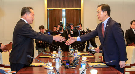 South Korean Unification Minister Cho Myoung-gyon shakes hands with his North Korean counterpart Ri Son Gwon during their meeting at the truce village of Panmunjom, South Korea, June 1, 2018. Yonhap via REUTERS