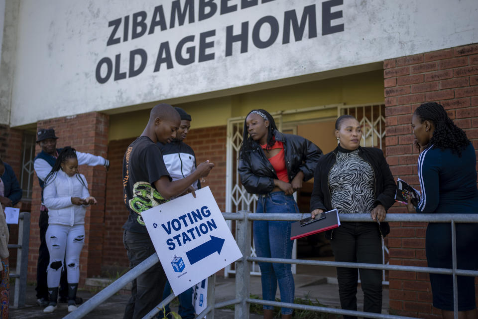 Electoral workers put up signs to indicate a polling station at Zibambeleni old age home in KwaDadeka, near Durban, South Africa, Monday, May 27, 2024. South Africans who received special permission to vote early were casting their ballots on Monday, ahead of main elections on May. 29. The special voting is for registered voters who are unable to travel to a voting station because of physical challenges such as disability, pregnancy or advanced age. (AP Photo/Emilio Morenatti)