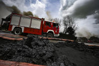 A firetruck is on site at a deadly fire at a large oil storage facility in Matanzas, Cuba, Tuesday, Aug. 9, 2022. The fire was triggered when lighting struck one of the facility's eight tanks late Friday, Aug. 5th. (Yamil Lage, Pool photo via AP)