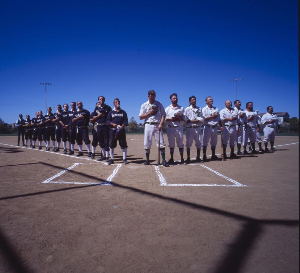 The Crestline Highlanders, right, and the Temecula Dear Brothers stand for the National Anthem.