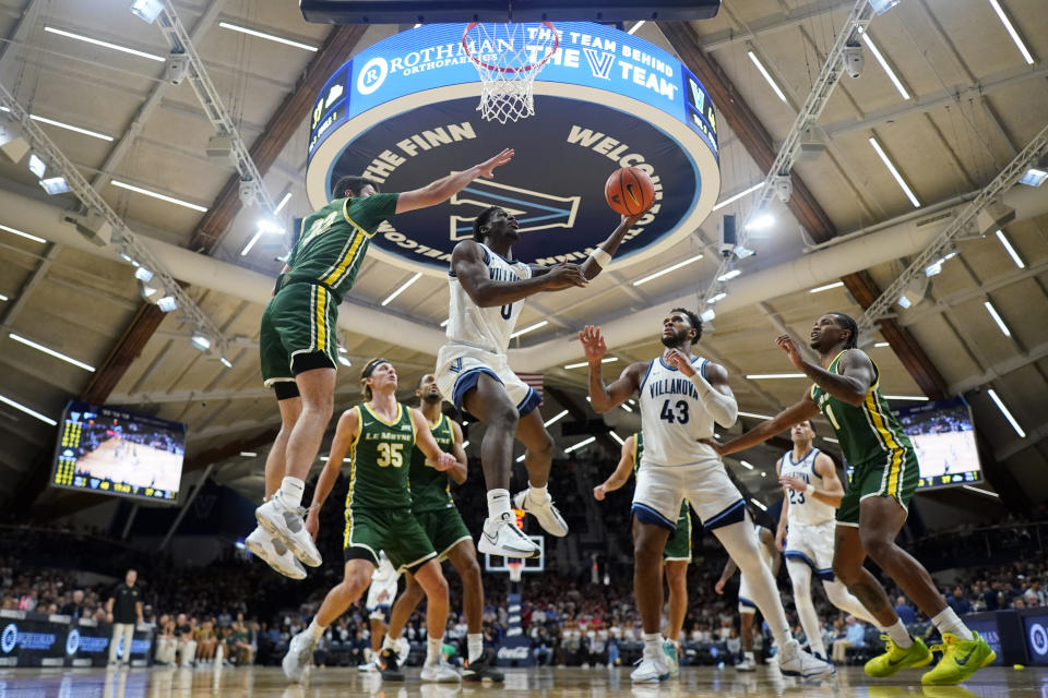 Villanova's TJ Bamba (0) goes up for a shot past Le Moyne's Luke Sutherland (23) during the second half of an NCAA college basketball game, Friday, Nov. 10, 2023, in Villanova, Pa. (AP Photo/Matt Slocum)