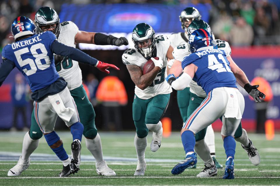 Jan 7, 2024; East Rutherford, New Jersey, USA; Philadelphia Eagles running back Rashaad Penny (23) carries the ball as New York Giants linebacker Micah McFadden (41) and linebacker Bobby Okereke (58) pursue during the second half at MetLife Stadium. Mandatory Credit: Vincent Carchietta-USA TODAY Sports