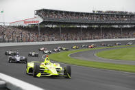 FILE - In this May 26, 2019, file photo, Simon Pagenaud, of France, leads the field through the first turn on the start of the Indianapolis 500 IndyCar auto race at Indianapolis Motor Speedway, in Indianapolis. The Indianapolis 500 scheduled for May 24 has been postponed until August because of the coronavirus pandemic and won't run on Memorial Day weekend for the first time since 1946. The race will instead be held Aug. 23. (AP Photo/Darron Cummings, File)