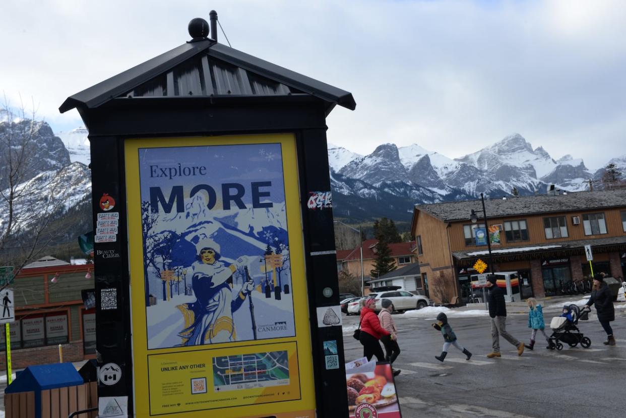 Pedestrians cross the main drag in downtown Canmore in February 2023. (Helen Pike/CBC - image credit)