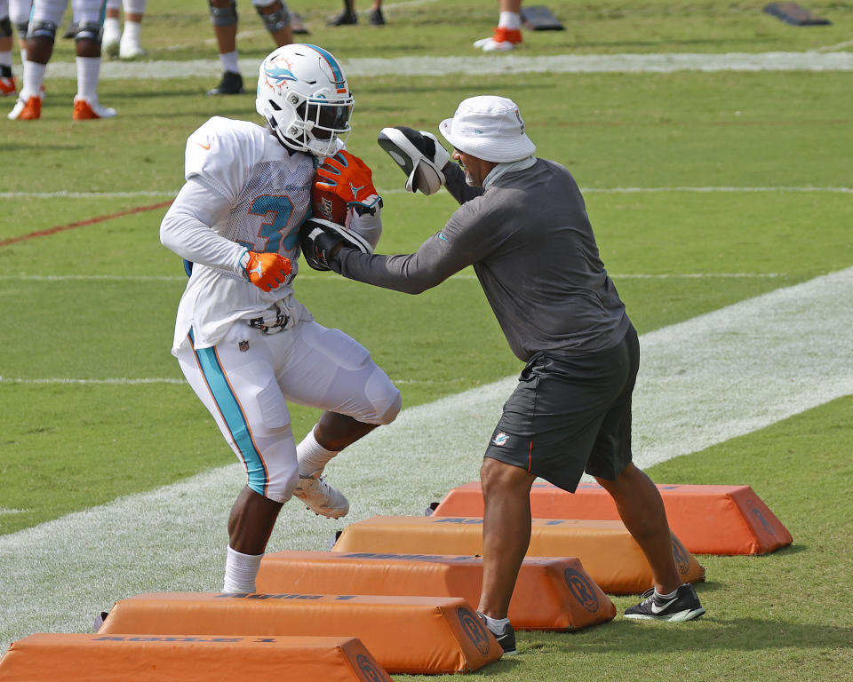 Miami Dolphins running back Jordan Howard (34) runs a drill during an NFL football training camp practice in Davie, Fla., Monday, Aug. 17, 2020. (AP Photo/Joel Auerbach)