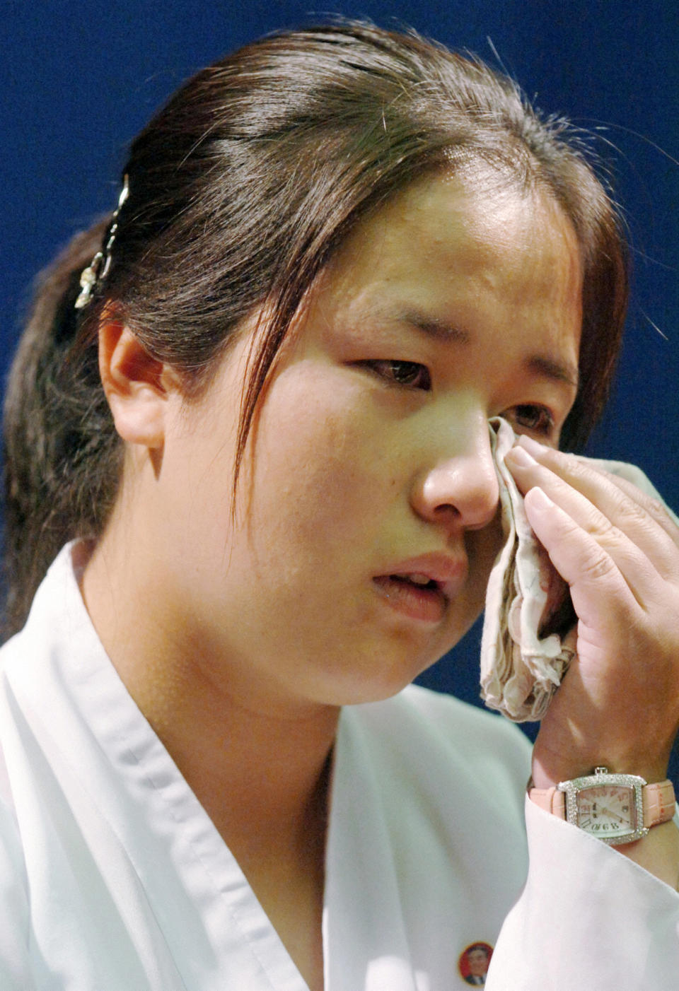 FILE - In this July 6, 2006 file photo, Kim Un Kyong, who's Japanese mother Megumi Yokota was adducted by North Korea in 1977, is moved to tears while speaking about her Japanese grandparents, Shigeru and Sakie Yokota, during a press conference at a hotel in Pyongyang, North Korea. Japan's Foreign Ministry confirmed Sunday, March 16, 2014, that Shigeru Yokota and his wife Sakie spent spent time with their Korean-born granddaughter Kim, for the first time over several days last week in Ulan Bator, Mongolia. Kim is 26 years old, Japanese media said. (AP Photo/Kyodo News, File) JAPAN OUT, MANDATORY CREDIT