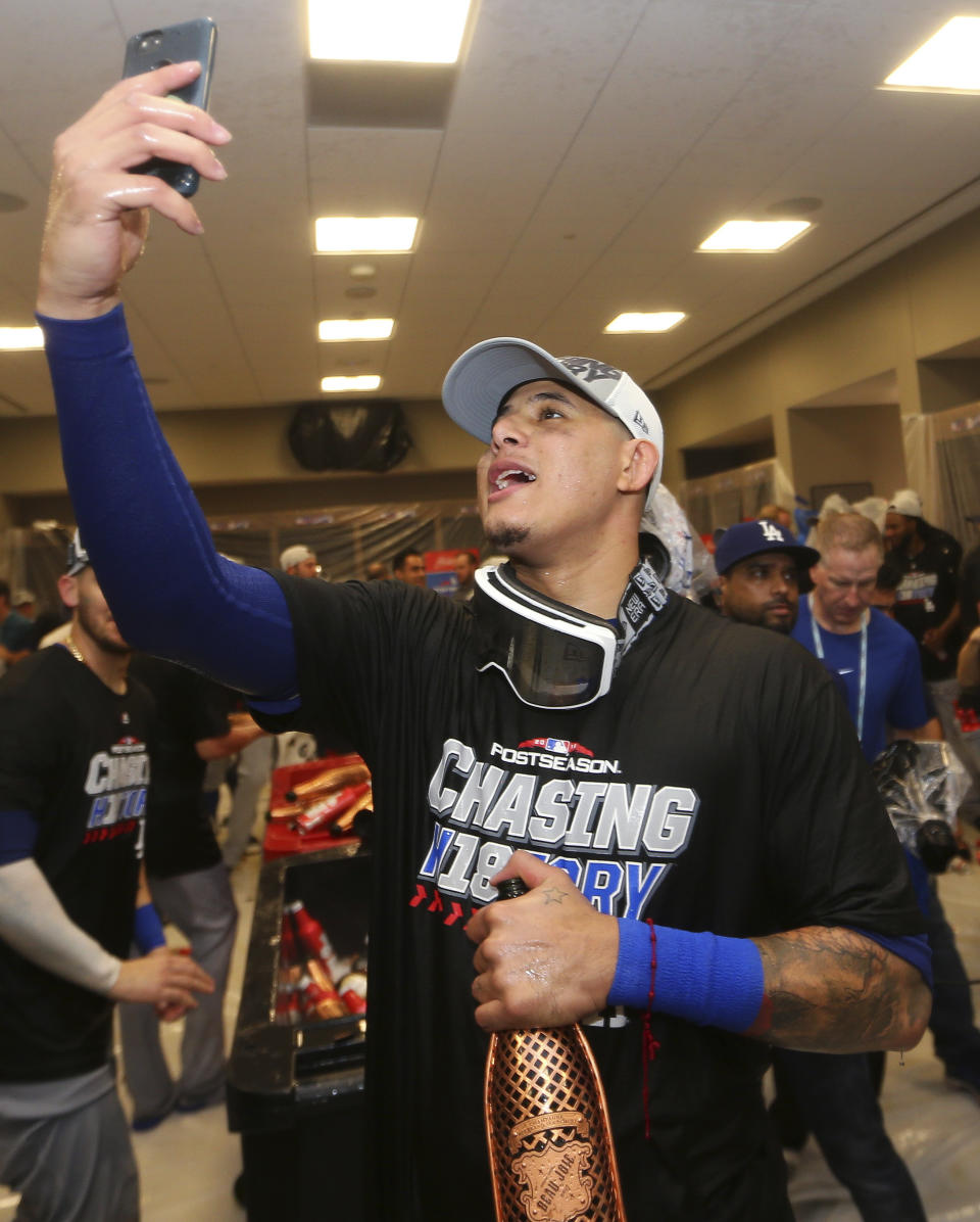 Los Angeles Dodgers Manny Machado takes a photo in the clubhouse after Game 4 of baseball's National League Division Series against the Atlanta Braves, Monday, Oct. 8, 2018, in Atlanta. The Los Angeles Dodgers won 6-2. (AP Photo/John Bazemore)