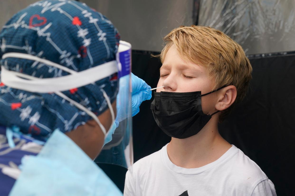 A boy in Miami receives a Covid test on 9 August, 2021.  (AP)