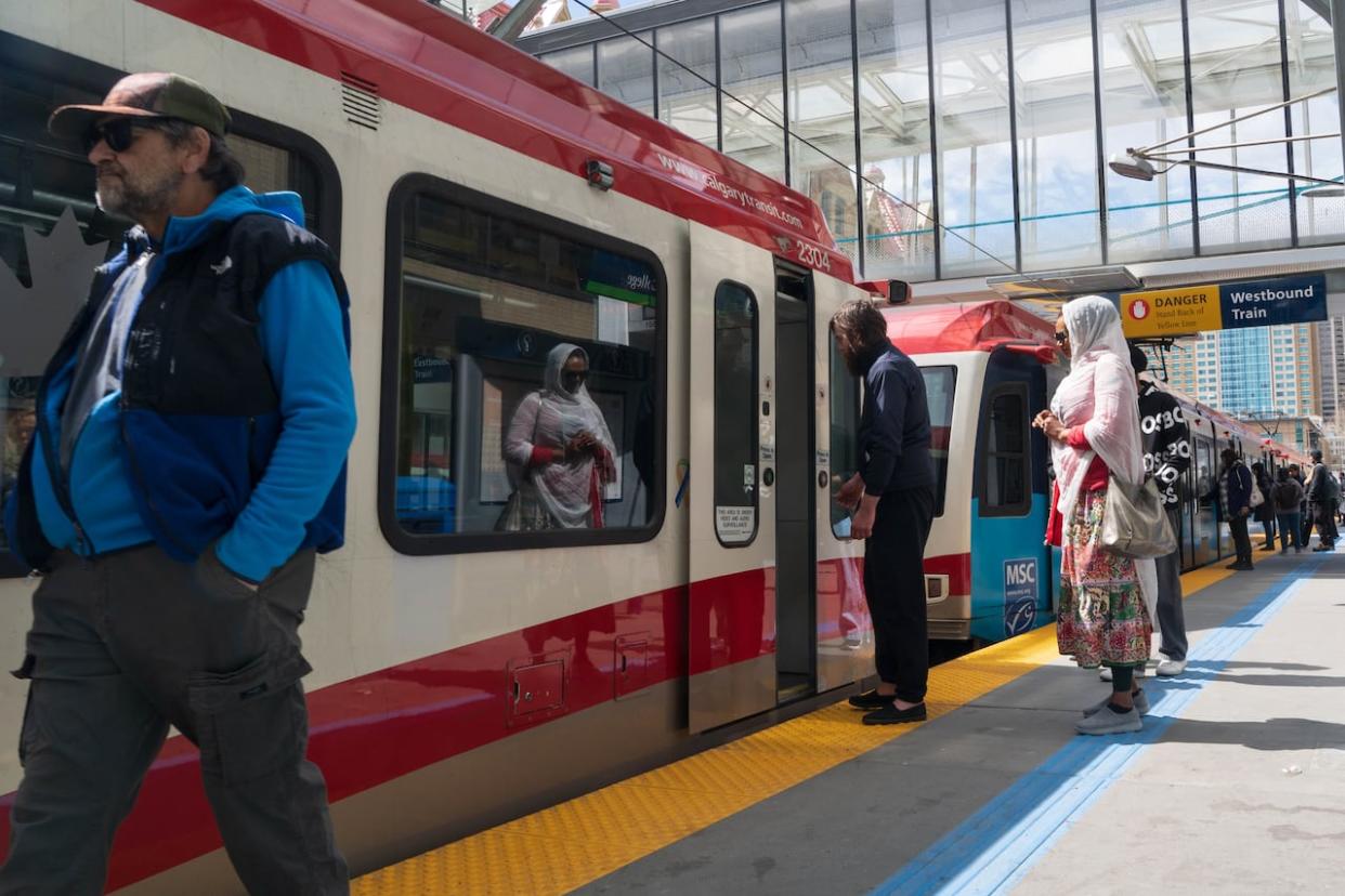 People getting on and off the CTrain at a station in downtown Calgary in this file photo from May 2024.  (Ose Irete/CBC - image credit)