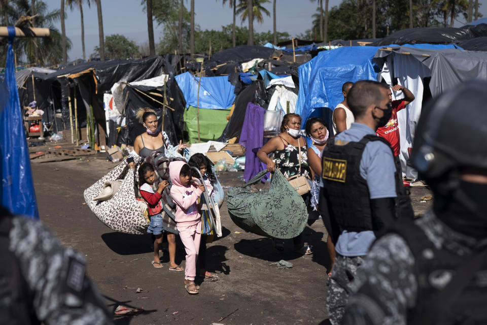 People are evicted from land designated for a Petrobras refinery, at a settlement coined the "First of May Refugee Camp," referring to the date people moved here and set up tents and shacks to live in during the new coronavirus pandemic in Itaguai, Rio de Janeiro state, Brazil, Thursday, July 1, 2021. (AP Photo/Silvia Izquierdo)