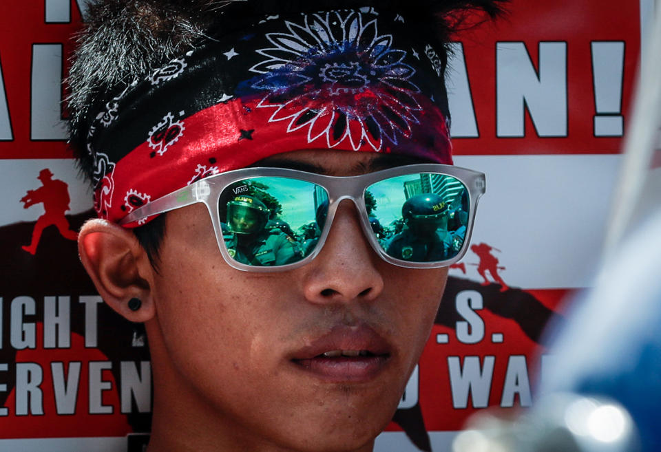 <p>Filipino anti-riot police are reflected on a protester’s sunglasses during a protest in Manila, Philippines, May 17, 2017. The protesters from the group Bayan reiterated its opposition to the US military presence in the Philippines. They are condemning Duterte’s administration in allowing the Philippine and US military exercises to take place, stating that it goes against Duterte’s vow to pursue an independent foreign policy. (Photo: Mark R. Cristino/EPA) </p>