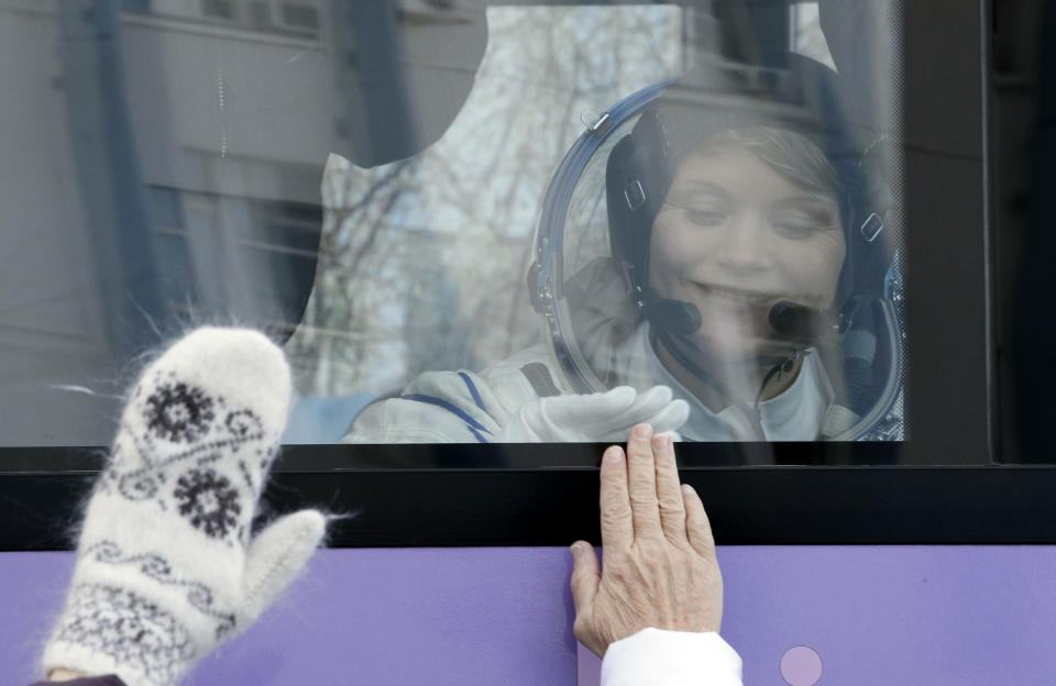 U.S. astronaut Anne McClain, member of the main crew to the International Space Station (ISS), interacts with her family from a bus prior to the launch of Soyuz-FG rocket at the Russian leased Baikonur cosmodrome, Kazakhstan, Monday, Dec. 3, 2018. (AP Photo/Dmitri Lovetsky, Pool)