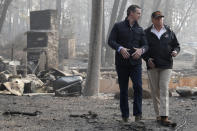 FILE - In this Nov. 17, 2018, file photo, President Donald Trump talks with then California Gov.-elect Gavin Newsom during a visit to a neighborhood destroyed by the wildfires in Paradise, Calif. Gov. Newsom is wrapping up a first year highlighted by the bankruptcy of the country's largest utility, an escalating homelessness crisis and an intensifying feud with the Trump administration, along with record-low unemployment and a booming state economy producing a multi-billion-dollar surplus. (AP Photo/Evan Vucci, File)