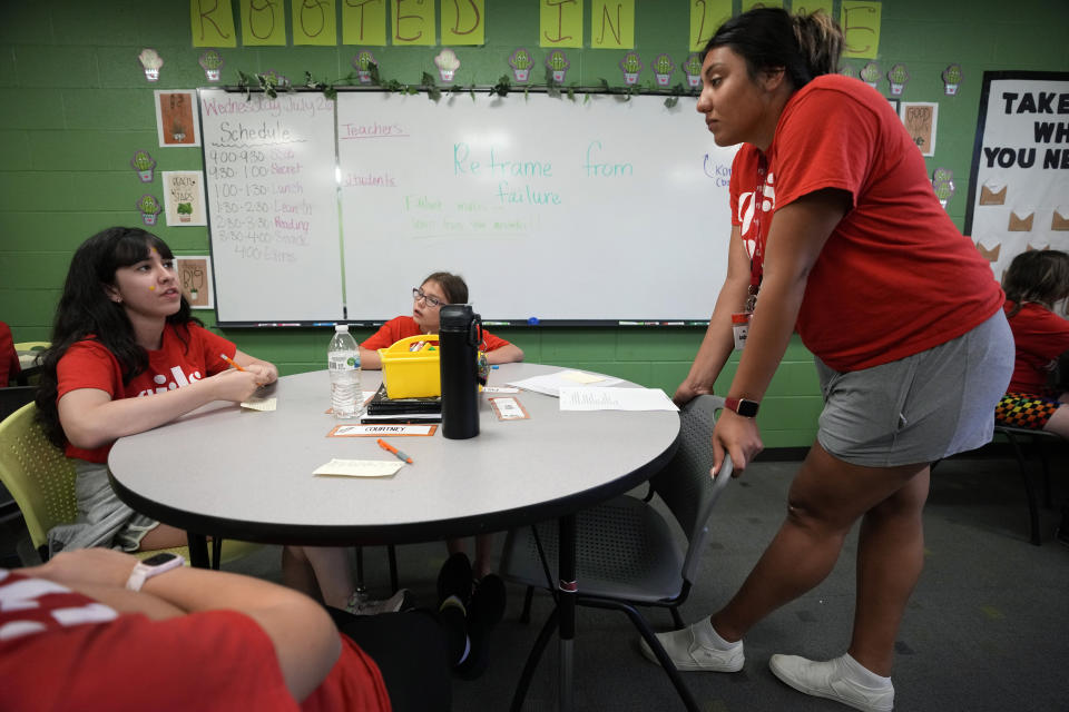 Program Specialist Andrea Vazquez, right, talks with a student during a Lean In session at Girls Inc., Wednesday, July 26, 2023, in Sioux City, Iowa. Ten years after publishing her book “Lean In: Women, Work and the Will to Lead,” Sheryl Sandberg will launch a girls leadership program Thursday, July 27, through her foundation to respond to what she calls stubborn gender inequities. (AP Photo/Charlie Neibergall)