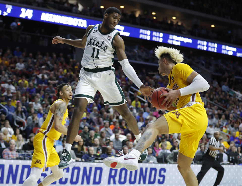 <p>Minnesota forward Jarvis Omersa, right, grabs a rebound in front of Michigan State forward Aaron Henry (11) during a second round men’s college basketball game in the NCAA Tournament, Saturday, March 23, 2019, in Des Moines, Iowa. (AP Photo/Charlie Neibergall) </p>