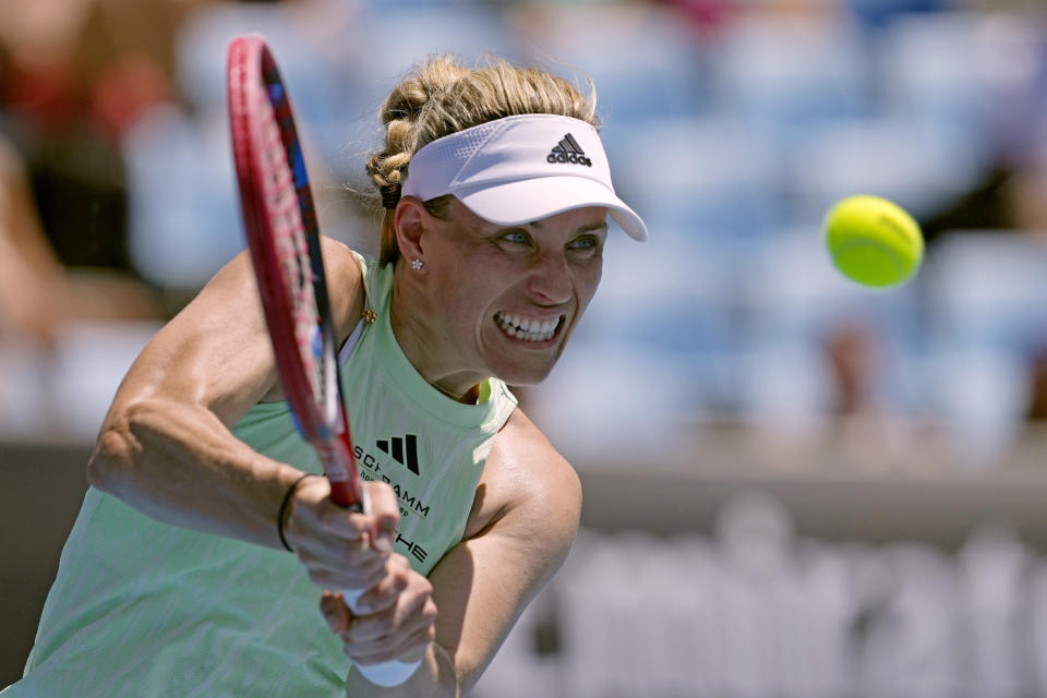 Angelique Kerber of Germany plays a backhand return to Danielle Collins of the U.S. during their first round match at the Australian Open tennis championships at Melbourne Park, Melbourne, Australia, Tuesday, Jan. 16, 2024. (AP Photo/Alessandra Tarantino)