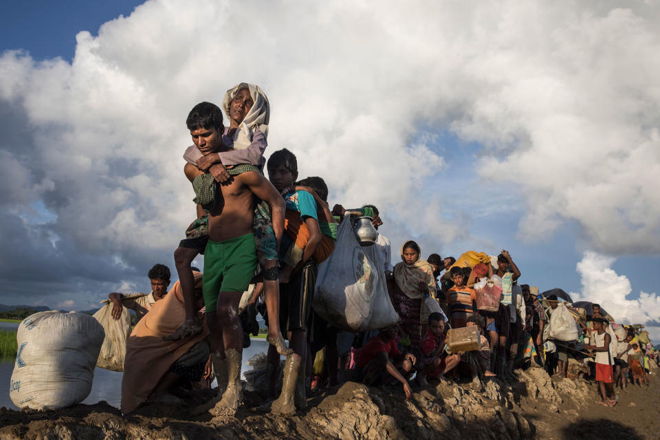 Thousands of Rohingya refugees fleeing from Myanmar walk along a muddy rice field after crossing the border in Palang Khali, Cox’s Bazar, Bangladesh, on Oct. 9, 2017. (Photo: Paula Bronstein/Getty Images)
