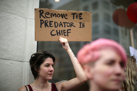 People participate in a protest march for survivors of sexual assault and their supporters in Hollywood, Los Angeles, California U.S. November 12, 2017. REUTERS/Lucy Nicholson