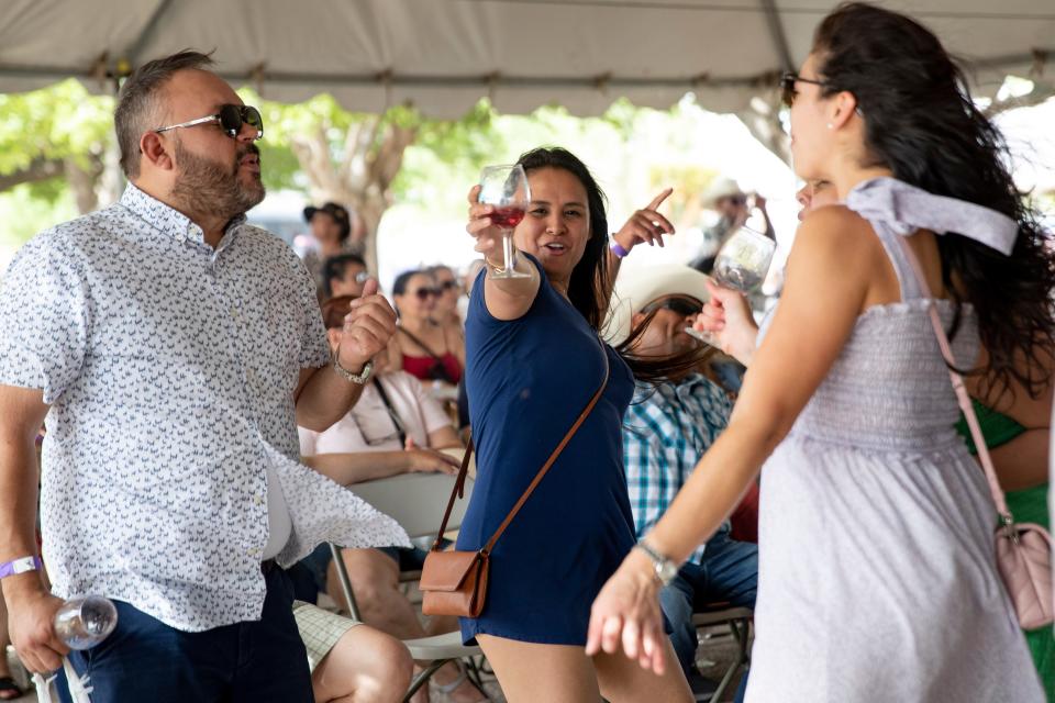 Festival-goers dance to the live music during the New Mexico Wine Festival at the Southern New Mexico State Fairgrounds  on Saturday, May 28, 2022. 