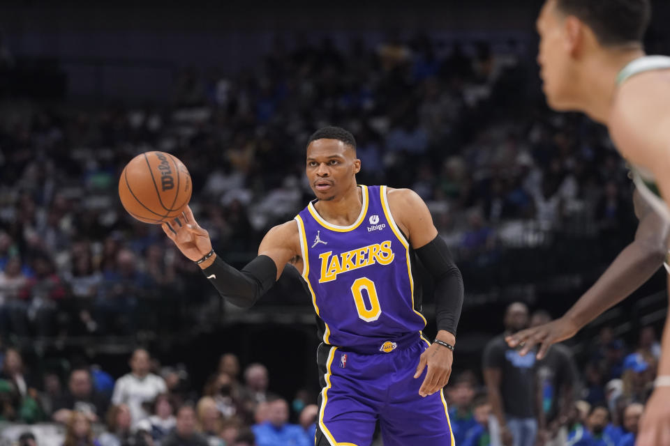 Los Angeles Lakers guard Russell Westbrook (0) passes off the ball during the first quarter of an NBA basketball game against the Dallas Mavericks in Dallas, Tuesday, March 29, 2022. (AP Photo/LM Otero)