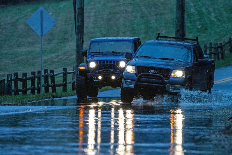 Cars cross streets flooded from an overnight storms of strong winds and rain. in New Castle, Ohio Wednesday, Jan. 10, 2024