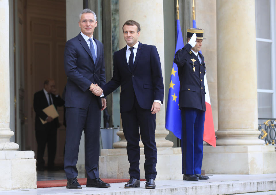 NATO Secretary General Jens Stoltenberg, left is welcomed by French President Emmanuel Macron at the Elysee Palace in Paris, Thursday, Nov. 28, 2019. NATO chief Jens Stoltenberg is to meet in Paris with French President Emmanuel Macron, whose recent public statement that it is "brain dead" has shaken the military alliance. (AP Photo/Michel Euler)