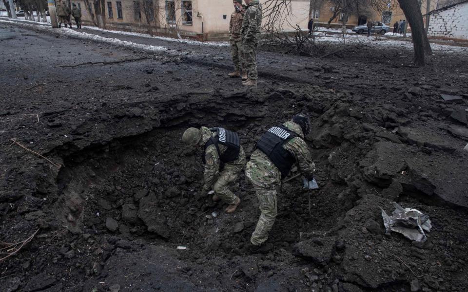 Police collect missile debris in central Kramatorsk - Julian Simmonds for The Telegraph 