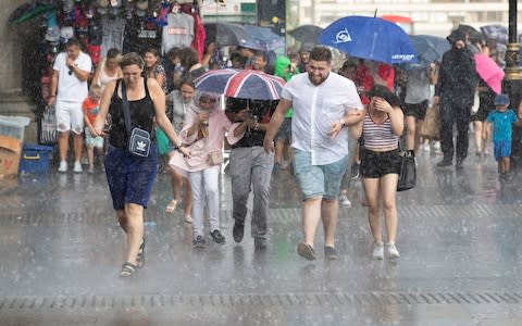 People get caught in a sudden downpour near Parliament as heavy rain ends the long dry spell. - Credit: Peter Macdiarmid/LNP