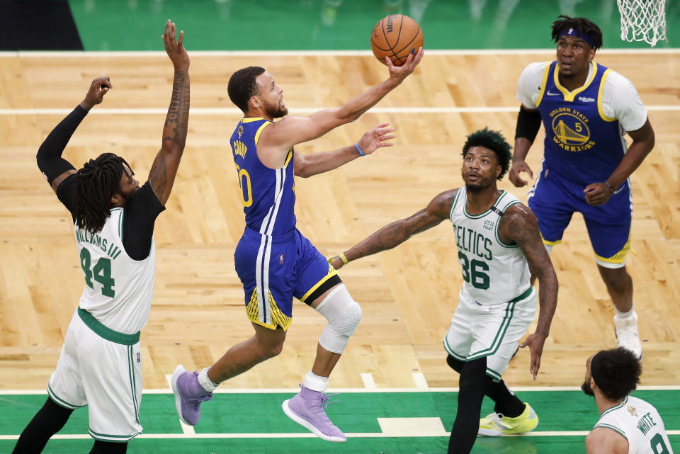 Golden State Warriors guard Stephen Curry (30) goes up for a shot against Boston Celtics guard Marcus Smart (36) and center Robert Williams III (44) during the first quarter of Game 6 of basketball's NBA Finals, Thursday, June 16, 2022, in Boston. (AP Photo/Michael Dwyer)