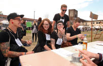 BERLIN, GERMANY - JULY 21: Attendees sign up to compete at the second annual Hipster Olympics on July 21, 2012 in Berlin, Germany. With events such as the "Horn-Rimmed Glasses Throw," "Skinny Jeans Tug-O-War," "Vinyl Record Spinning Contest" and "Cloth Tote Sack Race," the Hipster Olympics both mocks and celebrates the Hipster subculture, which some critics claim could never be accurately defined and others that it never existed in the first place. The imprecise nature of determining what makes one a member means that the symptomatic elements of adherants to the group vary in each country, but the archetype of the version in Berlin, one of the more popular locations for those following its lifestyle, along with London and Brooklyn, includes a penchant for canvas tote bags, the carbonated yerba mate drink Club Mate, analogue film cameras, asymetrical haircuts, 80s neon fashion, and, allegedly, a heavy dose of irony. To some in Berlin, members of the hipster "movement" have replaced a former unwanted identity in gentrifying neighborhoods, the Yuppie, for targets of criticism, as landlords raise rents in the areas to which they relocate, particularly the up-and-coming neighborhood of Neukoelln. (Photo by Adam Berry/Getty Images)