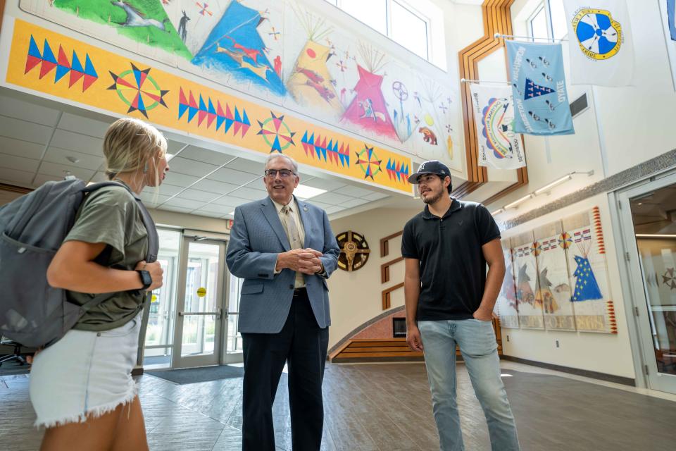 South Dakota State University President Barry Dunn (center) visits with students Harley Fischer (left) and Kevin Peterson (right) at the new American Indian Student Center on the SDSU campus.