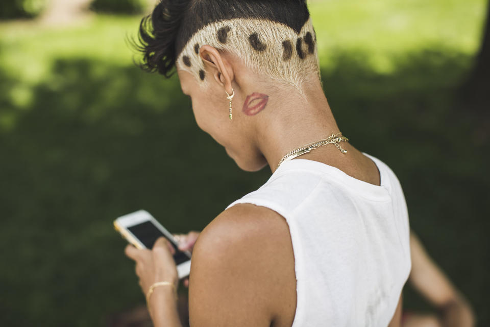 A person with lips tattooed on their neck